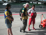 Customers chat with Rossi mechanic Alex Briggs on Sepang pit row
