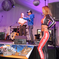 Friday night trackside opening party - charity auction. Czech rider Jakub Kornfeil on stage