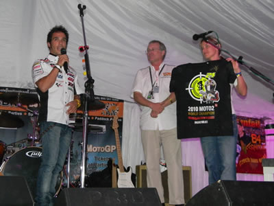 Toni Elias on stage auctioning his Moto2 world championship Tee shirt